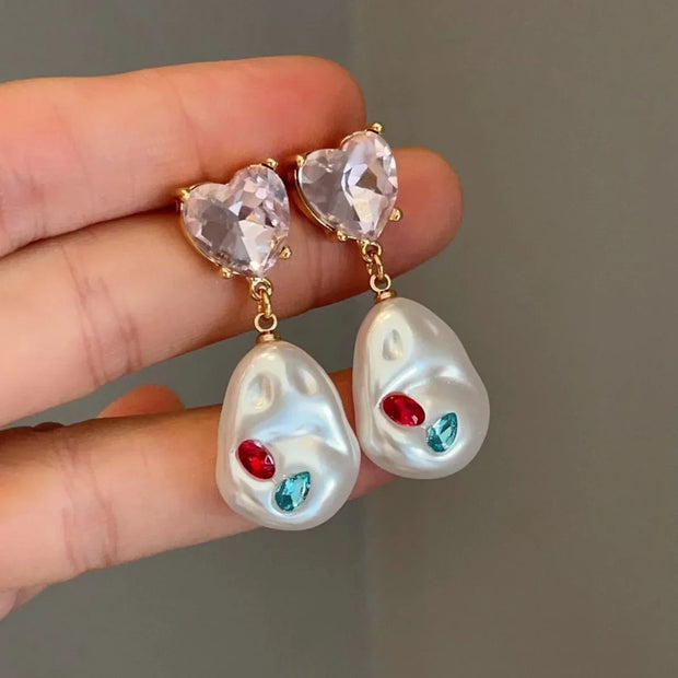 Unique eye and pearl drop earrings, ideal for jewelry storage, jewelry websites, vintage jewelry collections, and bold statement fashion for jewelry lovers.