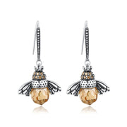 Bee-themed drop earrings with amber crystals and silver details, perfect for jewelry websites, jewelry storage, vintage jewelry, and nature-inspired fashion.