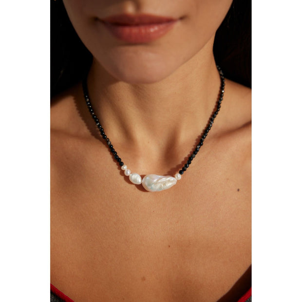 Black beaded necklace with a baroque pearl centerpiece, ideal for jewelry storage, jewelry websites, vintage jewelry collections, and elegant everyday fashion.