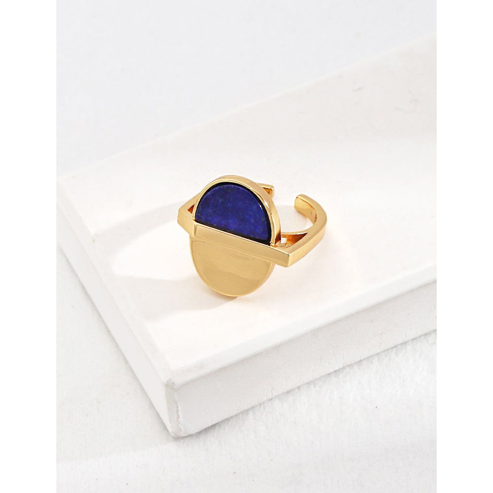Gold geometric ring with a blue stone, perfect for jewelry storage, jewelry websites, gem jewelry collections, and as a bold modern accessory for any occasion.