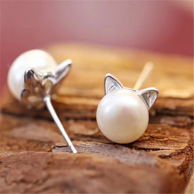 Adorable pearl stud earrings with silver cat ear accents, ideal for jewelry storage, vintage jewelry collections, or display on jewelry websites. Perfect for earrings piercing enthusiasts, jewelry cleaning tips, jewelry for mom gifts, and gem jewelry lovers. Great for permanent jewelry collections or pairing with body jewelry and earrings rings styles.