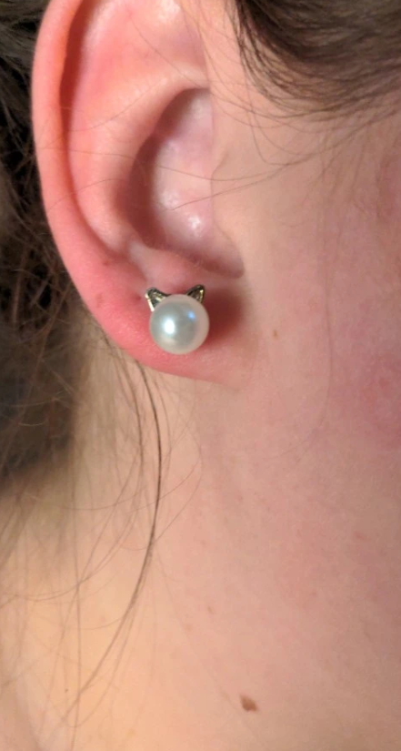 Adorable pearl stud earrings with silver cat ear accents, ideal for jewelry storage, vintage jewelry collections, or display on jewelry websites. Perfect for earrings piercing enthusiasts, jewelry cleaning tips, jewelry for mom gifts, and gem jewelry lovers. Great for permanent jewelry collections or pairing with body jewelry and earrings rings styles.