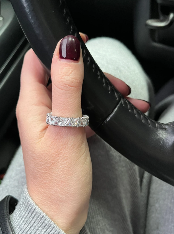 Luxurious diamond eternity ring with triangular-cut stones, perfect for jewelry cleaning, jewelry storage, vintage jewelry, and premium jewelry websites.