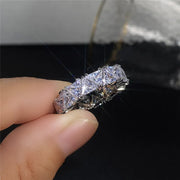 Luxurious diamond eternity ring with triangular-cut stones, perfect for jewelry cleaning, jewelry storage, vintage jewelry, and premium jewelry websites.