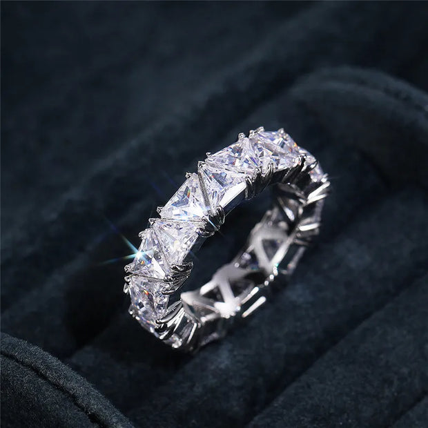 Luxurious diamond eternity ring with triangular-cut stones, perfect for jewelry cleaning, jewelry storage, vintage jewelry, and premium jewelry websites.