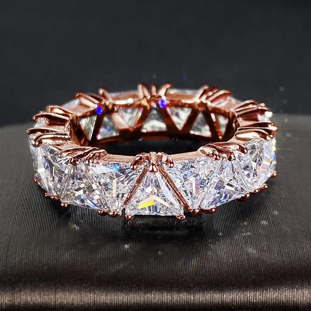 Luxurious diamond eternity ring with triangular-cut stones, perfect for jewelry cleaning, jewelry storage, vintage jewelry, and premium jewelry websites.