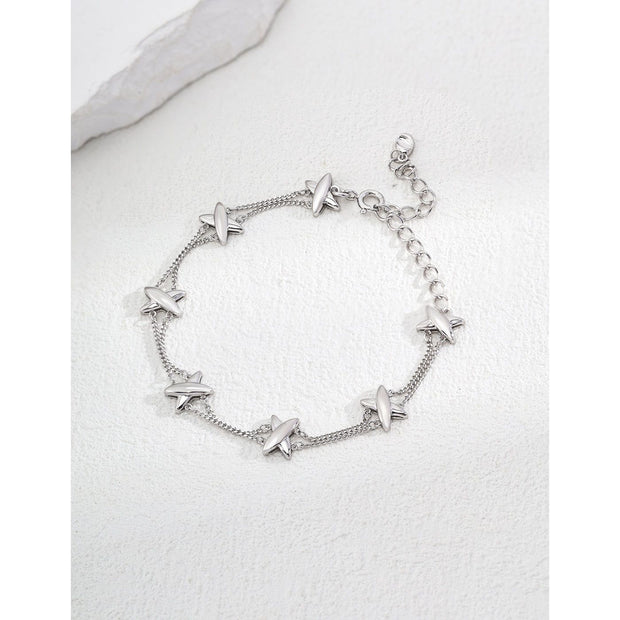 Silver charm bracelet with star accents and dual-chain design, ideal for jewelry storage, jewelry websites, vintage jewelry collections, and everyday elegance.