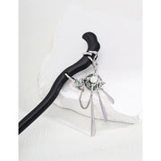 Elegant black hair stick with silver charms for mature women hairstyles, ideal for jewelry storage and jewelry cleaning. Perfect for jewelry designers, jewelry websites, and vintage jewelry lovers. Great for earrings piercing and body jewelry plus, as well as for those interested in permanent jewelry and jewelry repair close to me. A stylish addition for jewelry with turquoise, gem jewelry, and jewelry brands enthusiasts.