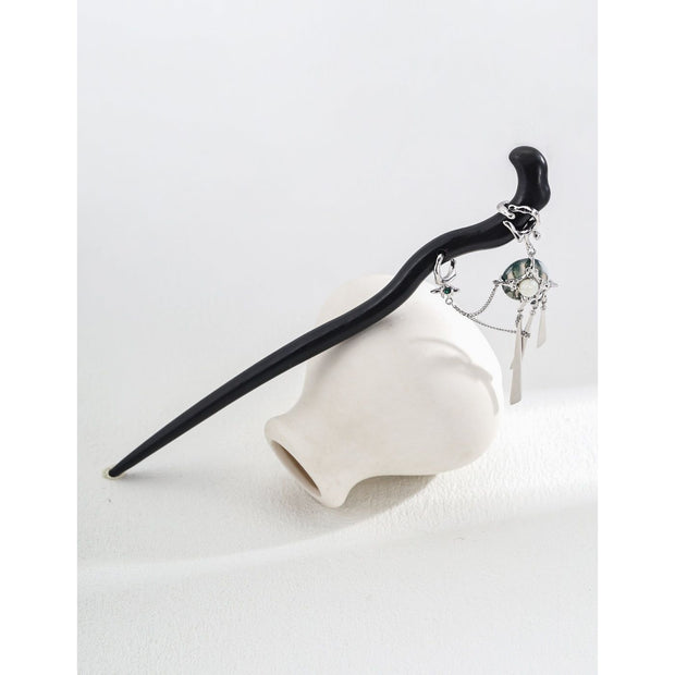 Elegant black hair stick with silver charms for mature women hairstyles, ideal for jewelry storage and jewelry cleaning. Perfect for jewelry designers, jewelry websites, and vintage jewelry lovers. Great for earrings piercing and body jewelry plus, as well as for those interested in permanent jewelry and jewelry repair close to me. A stylish addition for jewelry with turquoise, gem jewelry, and jewelry brands enthusiasts.