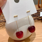 Cherry-inspired drop earrings with red stones and gold accents, perfect for jewelry websites, jewelry storage, vintage jewelry, and gifting for mom or jewelry lovers.
