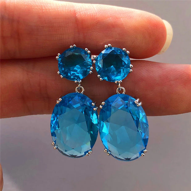 Elegant crystal drop earrings with sparkling oval-cut gems, perfect for mature women, modern earrings piercing, and vintage jewelry enthusiasts.