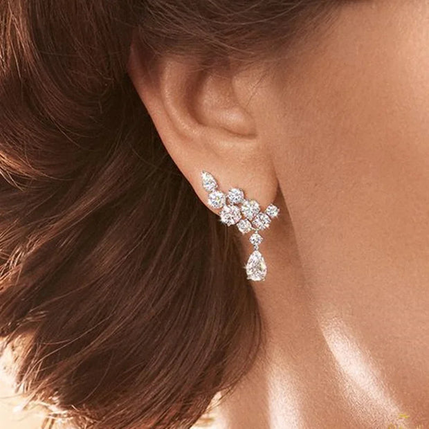 Crystal earrings in a velvet jewelry case, showcasing stunning craftsmanship by jewelry designers, perfect for elegant jewelry storage and earrings piercing styles.