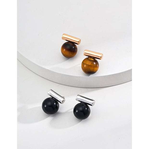 Elegant cufflinks with black and tiger eye stones in silver and gold accents, ideal for jewelry storage, jewelry websites, gem jewelry collections, and formal occasions.