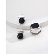 Elegant cufflinks with black and tiger eye stones in silver and gold accents, ideal for jewelry storage, jewelry websites, gem jewelry collections, and formal occasions.