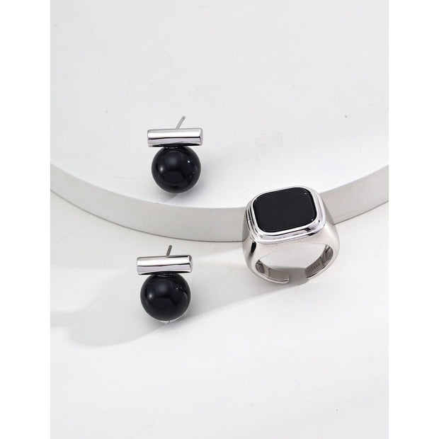 Elegant cufflinks with black and tiger eye stones in silver and gold accents, ideal for jewelry storage, jewelry websites, gem jewelry collections, and formal occasions.