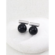Elegant cufflinks with black and tiger eye stones in silver and gold accents, ideal for jewelry storage, jewelry websites, gem jewelry collections, and formal occasions.