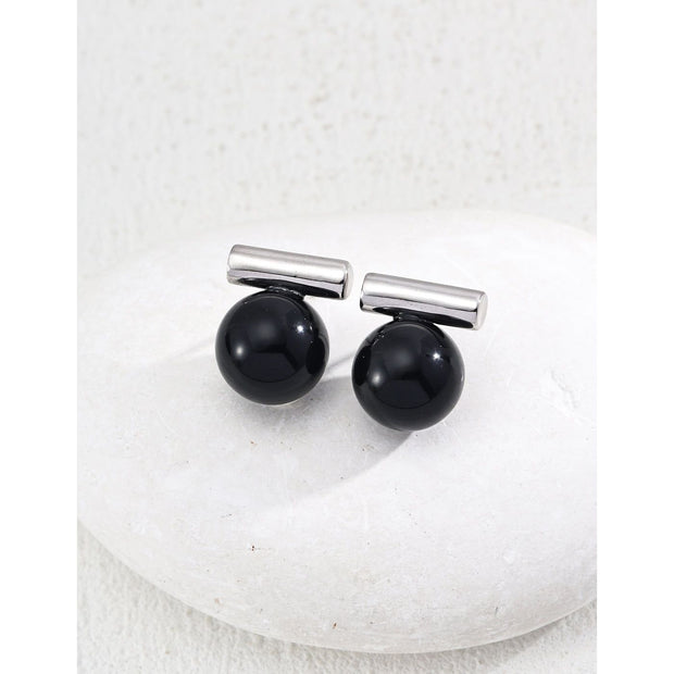 Elegant cufflinks with black and tiger eye stones in silver and gold accents, ideal for jewelry storage, jewelry websites, gem jewelry collections, and formal occasions.