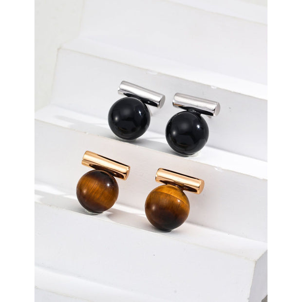 Elegant cufflinks with black and tiger eye stones in silver and gold accents, ideal for jewelry storage, jewelry websites, gem jewelry collections, and formal occasions.
