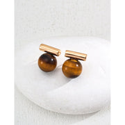 Elegant cufflinks with black and tiger eye stones in silver and gold accents, ideal for jewelry storage, jewelry websites, gem jewelry collections, and formal occasions.