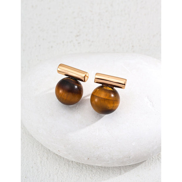 Elegant cufflinks with black and tiger eye stones in silver and gold accents, ideal for jewelry storage, jewelry websites, gem jewelry collections, and formal occasions.