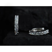 Silver hoop earrings with sparkling diamonds, perfect for jewelry storage, designed by expert jewelry designers, ideal for earrings piercing and diamond and jewelry lovers.