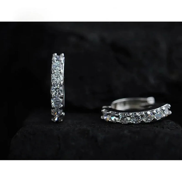 Silver hoop earrings with sparkling diamonds, perfect for jewelry storage, designed by expert jewelry designers, ideal for earrings piercing and diamond and jewelry lovers.