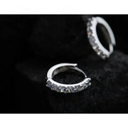 Silver hoop earrings with sparkling diamonds, perfect for jewelry storage, designed by expert jewelry designers, ideal for earrings piercing and diamond and jewelry lovers.
