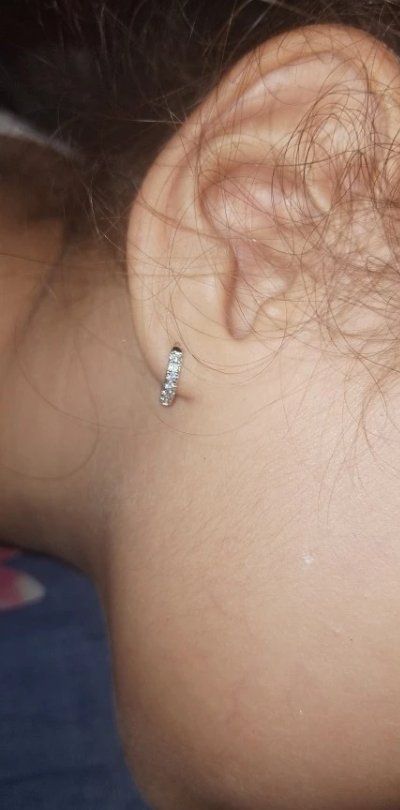 Silver hoop earrings with sparkling diamonds, perfect for jewelry storage, designed by expert jewelry designers, ideal for earrings piercing and diamond and jewelry lovers.