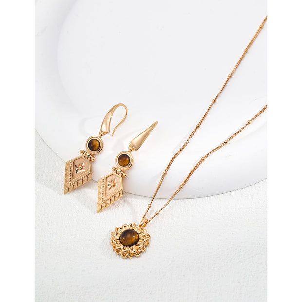 Vintage-inspired gold drop earrings with gemstones, ideal for earrings piercing, jewelry storage in a jewelry case, and perfect for jewelry designers and jewelry websites.