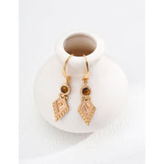 Vintage-inspired gold drop earrings with gemstones, ideal for earrings piercing, jewelry storage in a jewelry case, and perfect for jewelry designers and jewelry websites.