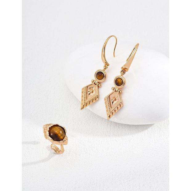 Vintage-inspired gold drop earrings with gemstones, ideal for earrings piercing, jewelry storage in a jewelry case, and perfect for jewelry designers and jewelry websites.