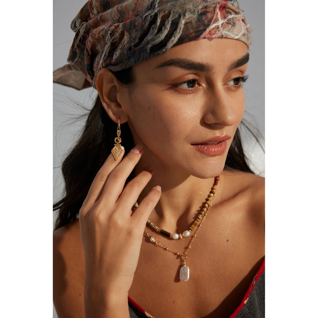 Vintage-inspired gold drop earrings with gemstones, ideal for earrings piercing, jewelry storage in a jewelry case, and perfect for jewelry designers and jewelry websites.