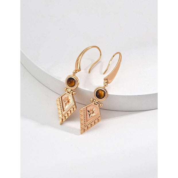 Vintage-inspired gold drop earrings with gemstones, ideal for earrings piercing, jewelry storage in a jewelry case, and perfect for jewelry designers and jewelry websites.