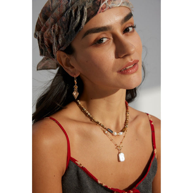 Vintage-inspired gold drop earrings with gemstones, ideal for earrings piercing, jewelry storage in a jewelry case, and perfect for jewelry designers and jewelry websites.