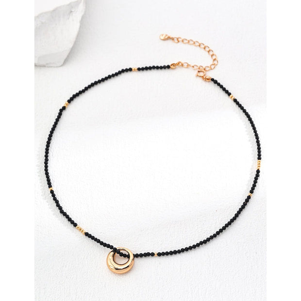 Gold-plated pendant necklace with black beads, ideal for jewelry storage, vintage jewelry collections, jewelry websites, and as a timeless accessory for any occasion.
