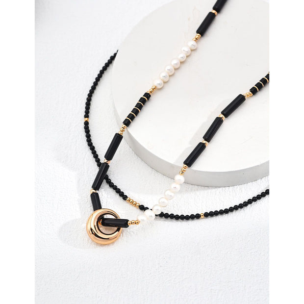 Gold-plated pendant necklace with black beads, ideal for jewelry storage, vintage jewelry collections, jewelry websites, and as a timeless accessory for any occasion.
