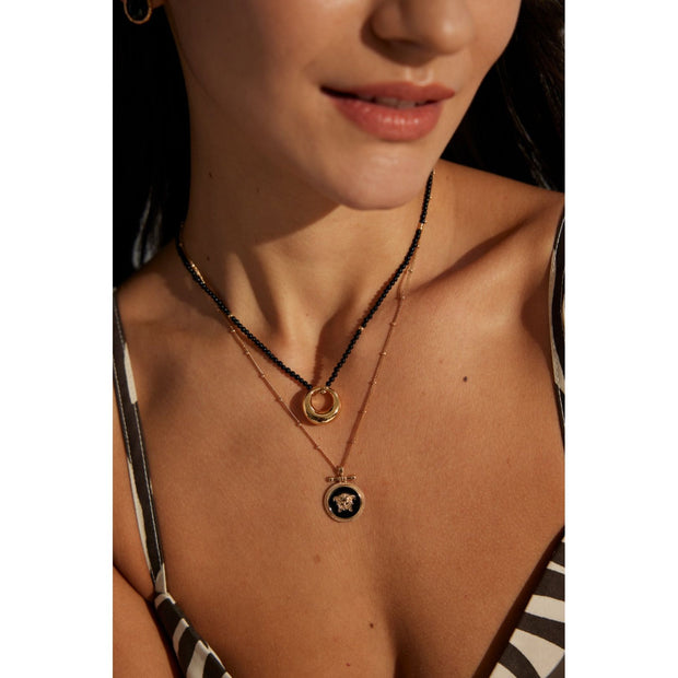 Gold-plated pendant necklace with black beads, ideal for jewelry storage, vintage jewelry collections, jewelry websites, and as a timeless accessory for any occasion.