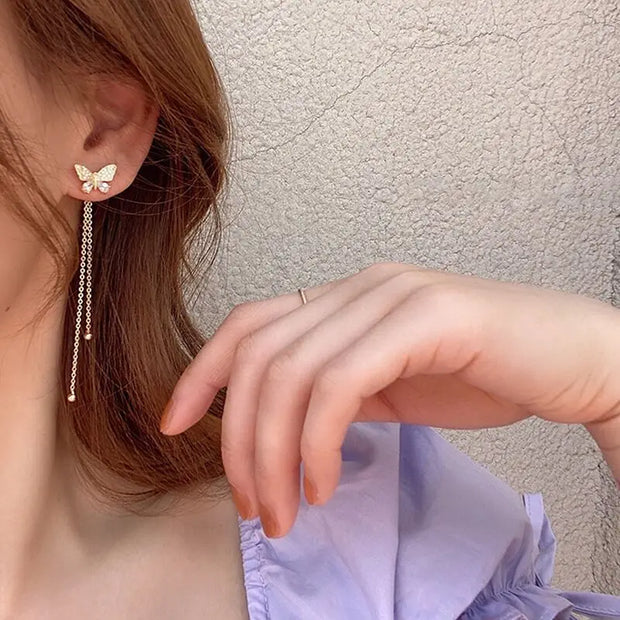 Butterfly gold earrings with dangling chains, perfect for earrings piercing, jewelry storage, jewelry websites, vintage jewelry, and jewelry for mom.