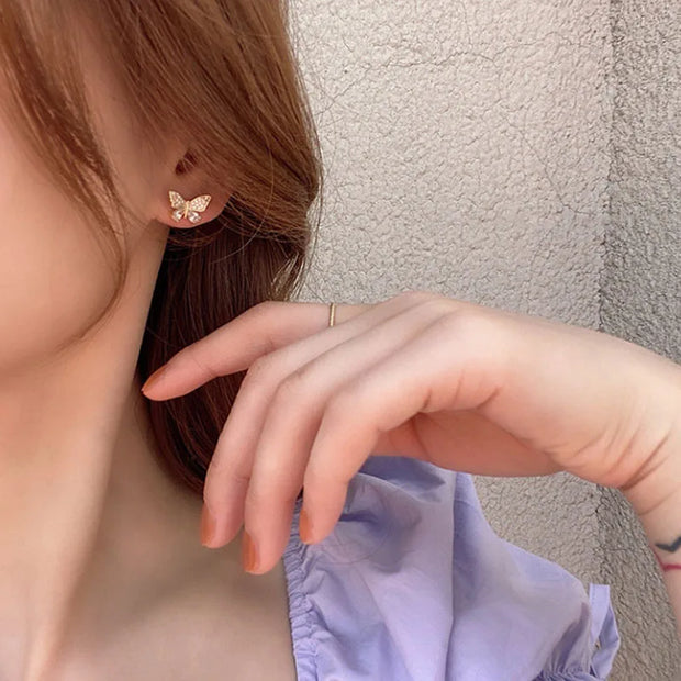 Butterfly gold earrings with dangling chains, perfect for earrings piercing, jewelry storage, jewelry websites, vintage jewelry, and jewelry for mom.