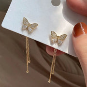 Butterfly gold earrings with dangling chains, perfect for earrings piercing, jewelry storage, jewelry websites, vintage jewelry, and jewelry for mom.