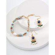 Gold earrings with blue gemstones, green beads, and pearl danglers, perfect for jewelry websites, jewelry storage, vintage jewelry, and jewelry for mom.
