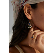 Gold earrings with blue gemstones, green beads, and pearl danglers, perfect for jewelry websites, jewelry storage, vintage jewelry, and jewelry for mom.