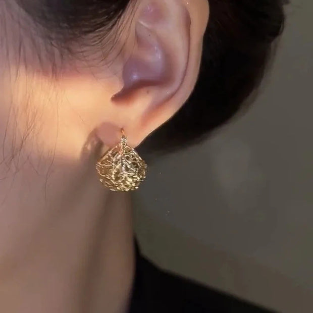 Gold filigree hoop earrings with intricate designs, perfect for jewelry storage, jewelry websites, vintage jewelry, and gifting for mom or elegant occasions.