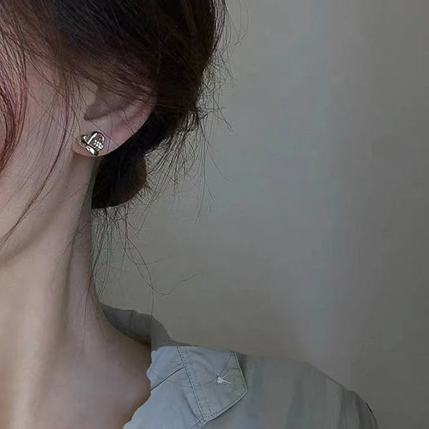 Gold heart knot earrings with crystals, ideal for jewelry cleaning, earrings piercing, jewelry storage, vintage jewelry, and gifts from top jewelry designers.