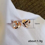 Gold heart knot earrings with crystals, ideal for jewelry cleaning, earrings piercing, jewelry storage, vintage jewelry, and gifts from top jewelry designers.