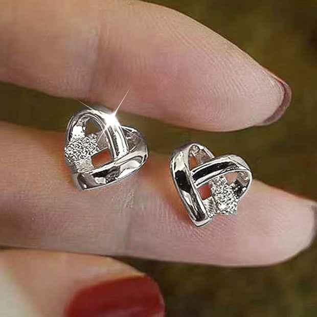 Gold heart knot earrings with crystals, ideal for jewelry cleaning, earrings piercing, jewelry storage, vintage jewelry, and gifts from top jewelry designers.