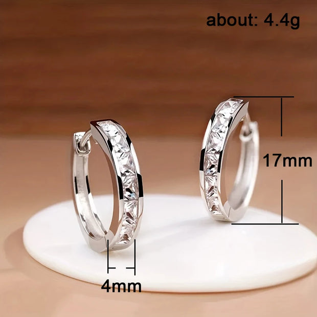 Elegant gold hoop earrings with crystals, perfect for jewelry storage in a jewelry case, crafted by expert jewelry designers. Ideal for lovers of earrings rings, gem jewelry, and body jewelry, available on top jewelry websites and jewelry brands. Great for earrings piercing fans and mature women hairstyles, these earrings also complement turquoise jewelry and vintage jewelry styles