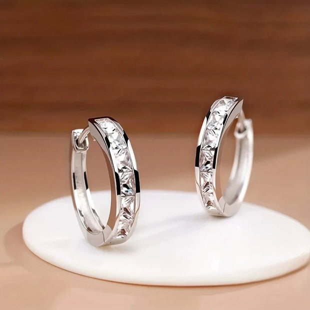 Elegant gold hoop earrings with crystals, perfect for jewelry storage in a jewelry case, crafted by expert jewelry designers. Ideal for lovers of earrings rings, gem jewelry, and body jewelry, available on top jewelry websites and jewelry brands. Great for earrings piercing fans and mature women hairstyles, these earrings also complement turquoise jewelry and vintage jewelry styles