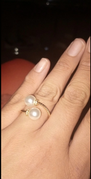 Gold twisted band pearl ring with diamonds displayed on a jewelry case. Ideal for jewelry cleaning, jewelry designers, vintage jewelry, and jewelry websites.