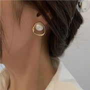 Elegant gold pearl stud earrings, perfect for jewelry cleaning, jewelry storage, jewelry websites, or featuring as a timeless piece by top jewelry designers.